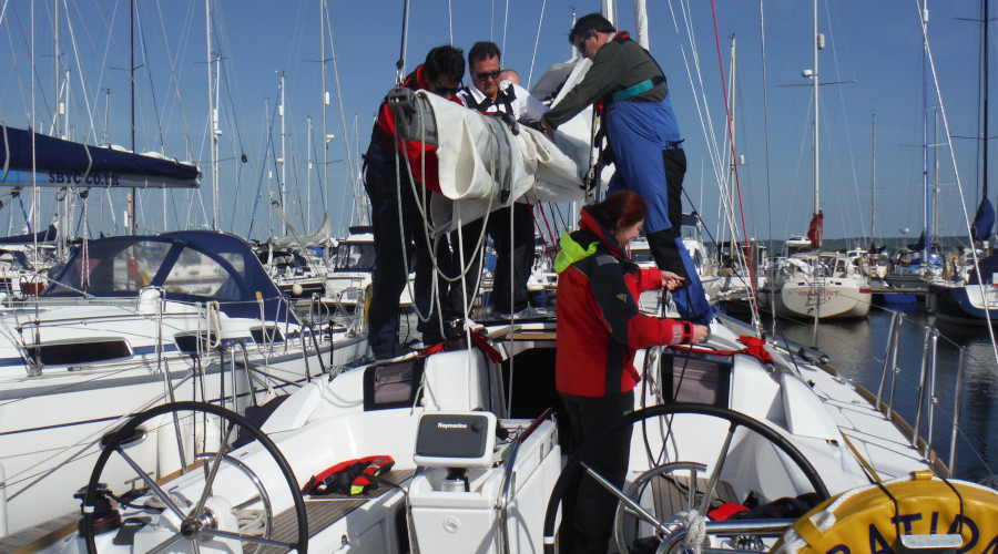 Preparing to go sailing for the day. RYA courses establish a strong routine making it easy to learn